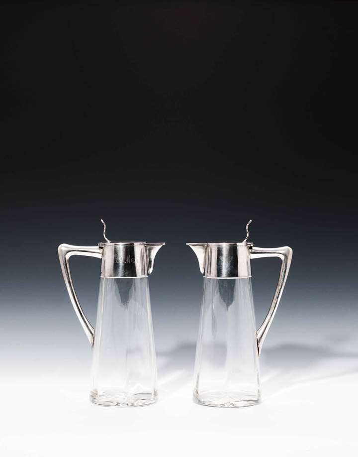 A PAIR OF JUGS WITH SILVER MOUNTS